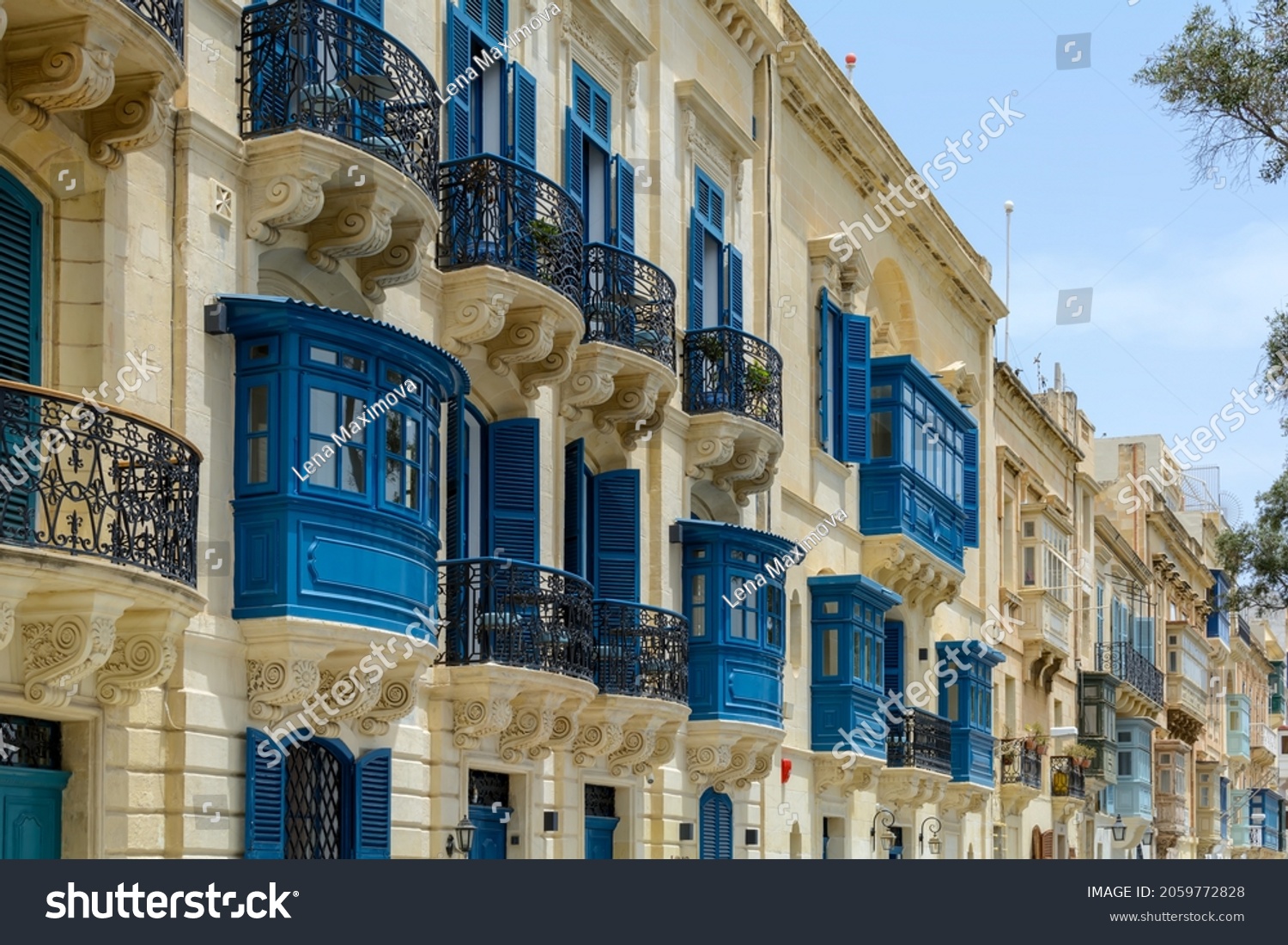 Residential house facade with traditional Maltese navy blue enclosed wooden balconies in Valletta, Malta, in summer day. Authentic Maltese urban scene. #2059772828