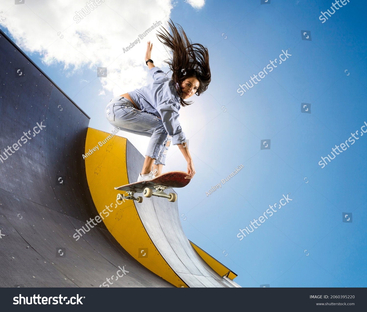 Skateboarder doing a jumping trick. Freestyle extreme sports concept #2060395220