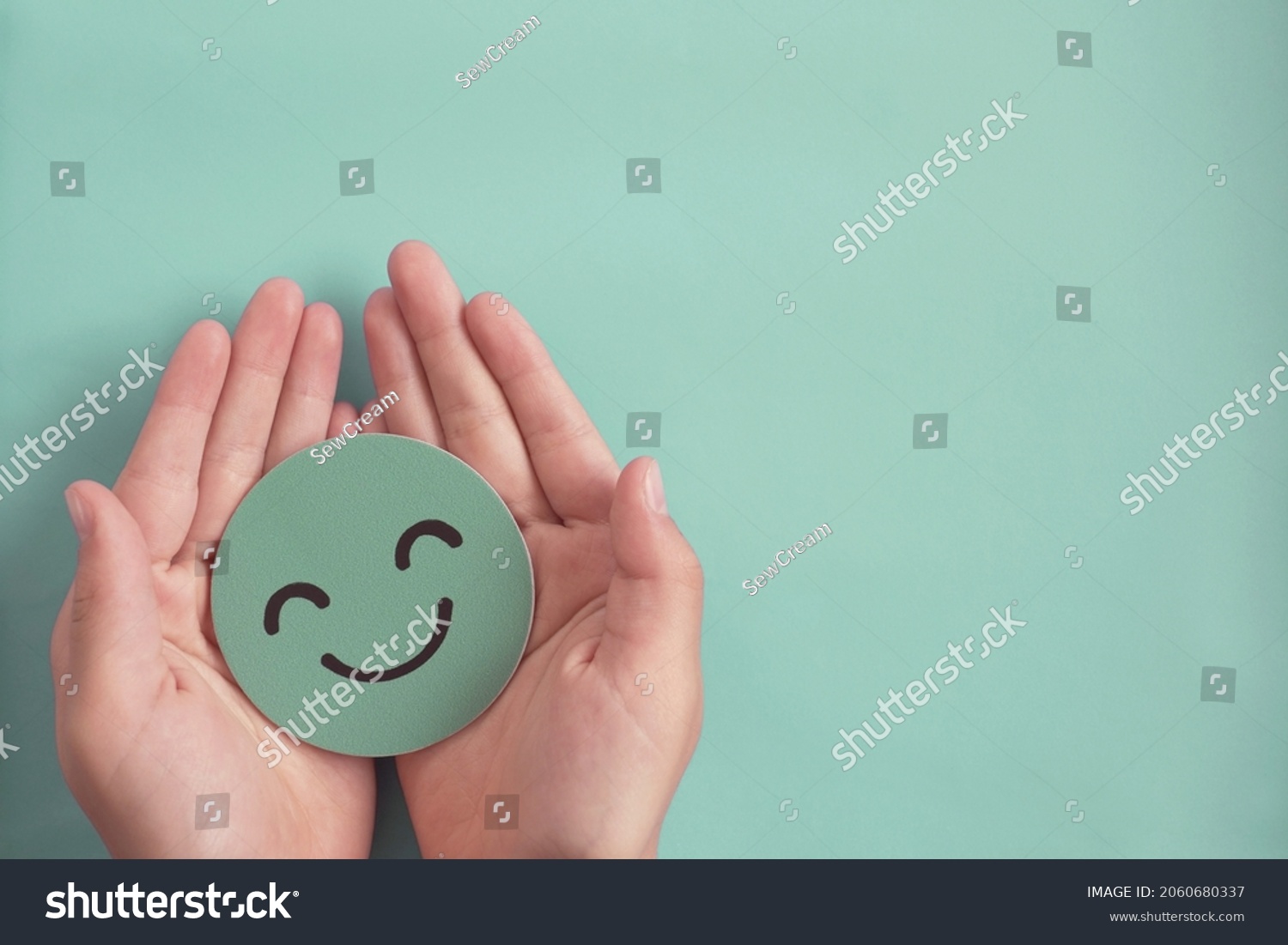 Hands holding green happy smile face , good feedback rating,positive customer review, experience, satisfaction survey ,mental health assessment, child wellness,world mental health day, Compliment Day #2060680337