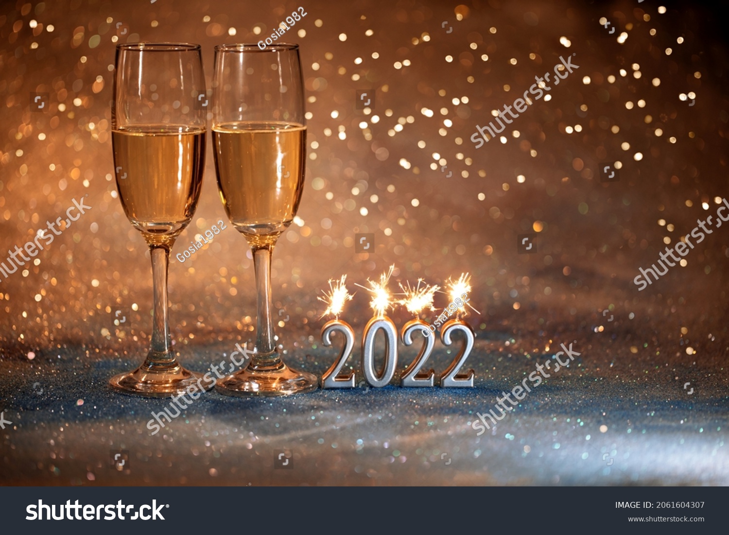 2022 New Year. Happy new year 2022 greeting card. Champagne glasses on glitter background #2061604307