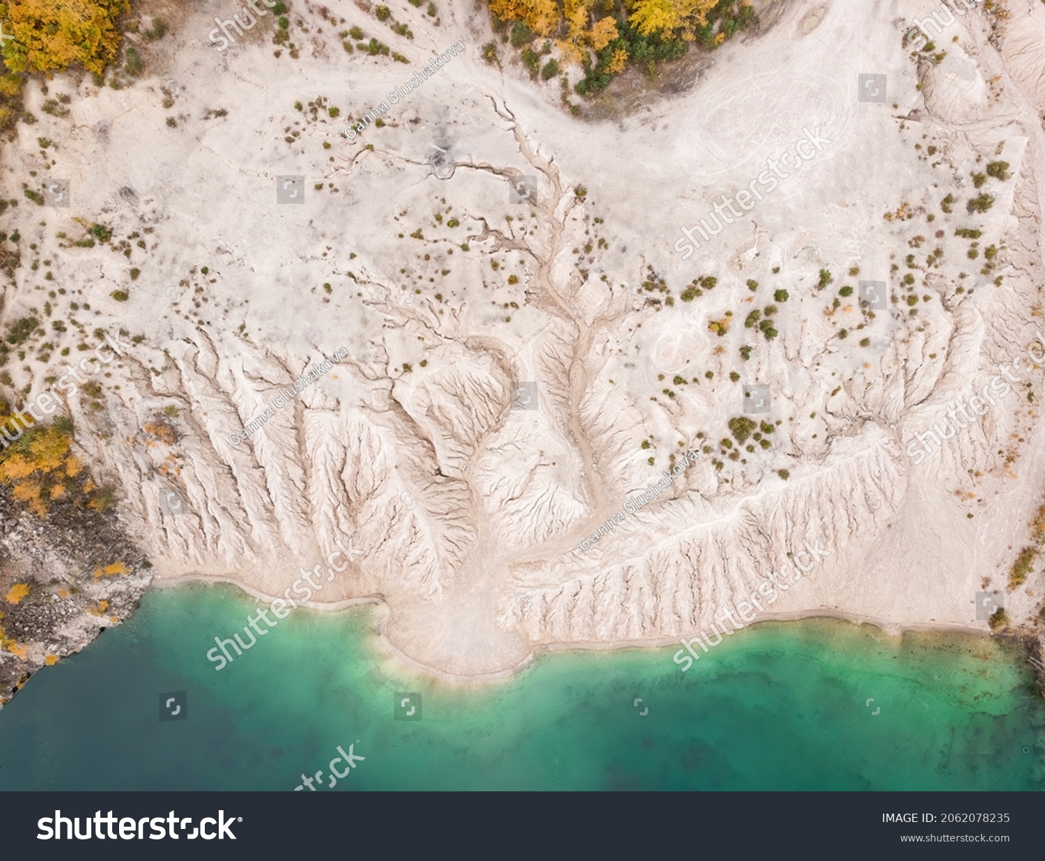 Rough texture of erosion in abandoned quarry, curves and smooth cuts resulting from the erosive effect of water, erosional water formation., abandoned and flooded quarry #2062078235