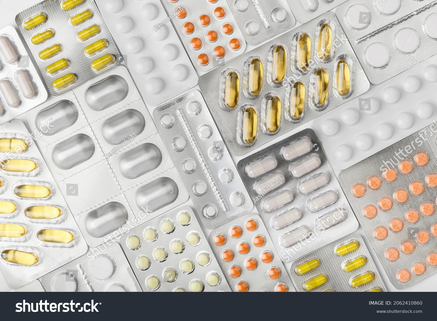Background fill of many blisters of medical pills, tablets. Treatment concept. Top view of pharmacy drug. Healthcare concept. pharmaceutical background from medicaments. Vitamin #2062410860