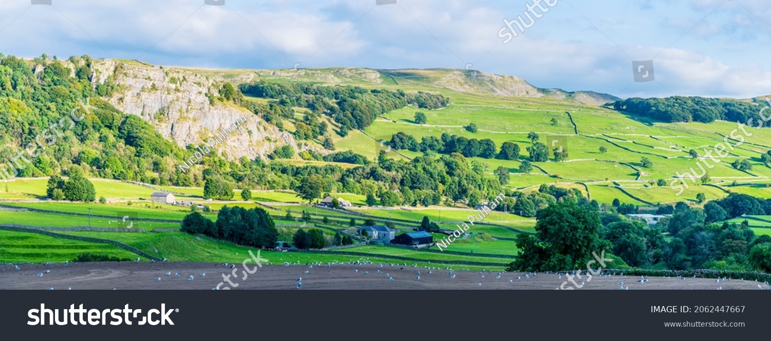 A panorama view over farmland in the River Ribble Valley near Settle, Yorkshire in summertime #2062447667