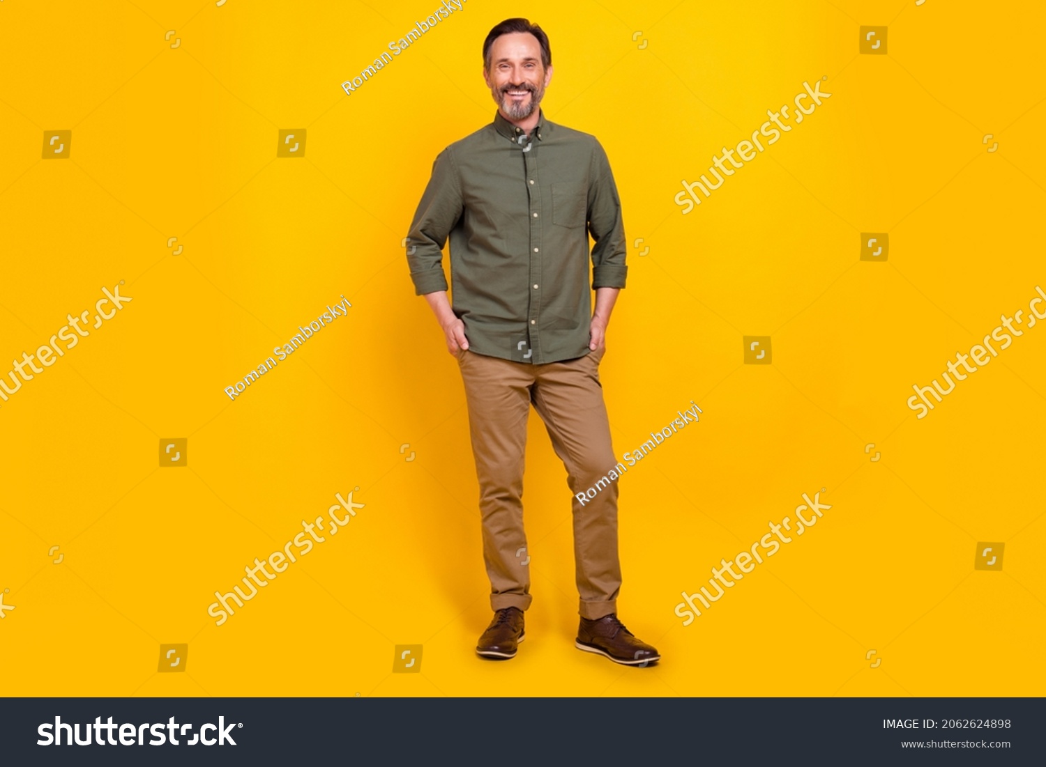 Full length body size view of attractive cheerful man employer holding hands in pockets isolated over vivid yellow color background #2062624898