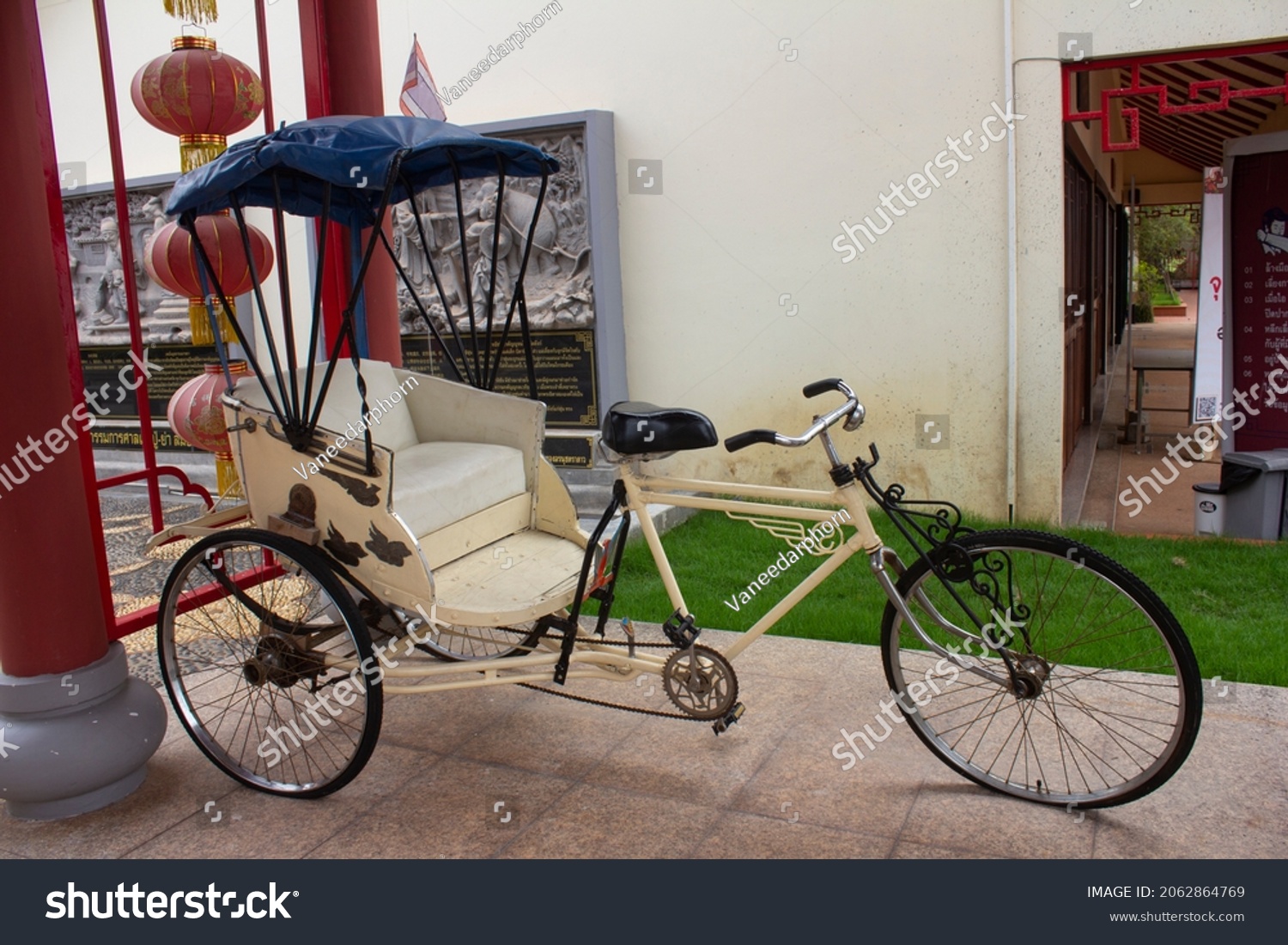 An old vintage tricycle showing for tourists to take photos at Thai-Chinese cultural center,Udon Thani,Thailand.Tricycle used to be the most hit of transportation in Udon Thani. #2062864769