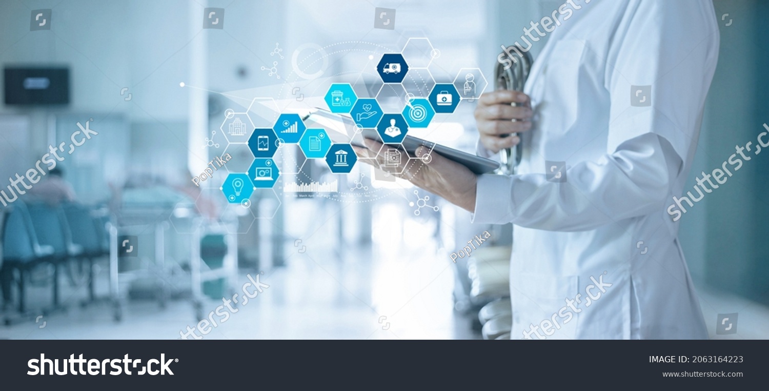 Healthcare business and Medical examination, Doctor use tablet and icon medical with analyzing data and growth chart on hospital background, Health Insurance, Medical business and technology concept. #2063164223