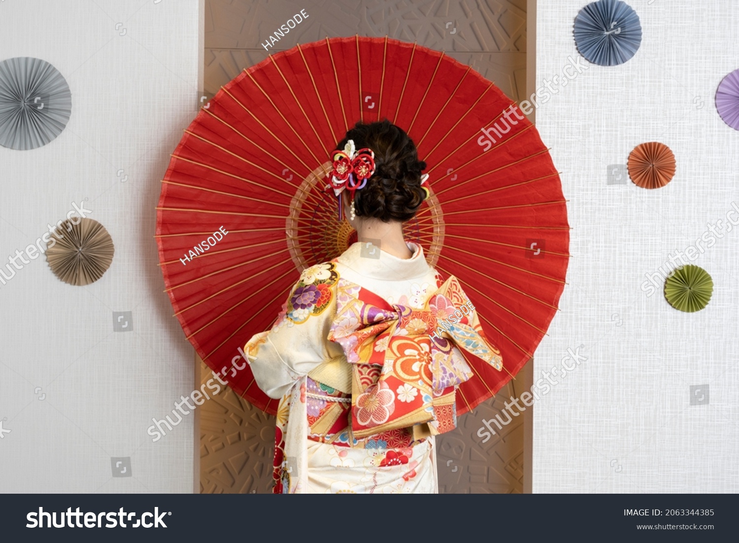 Female adult in kimono with an umbrella spread #2063344385