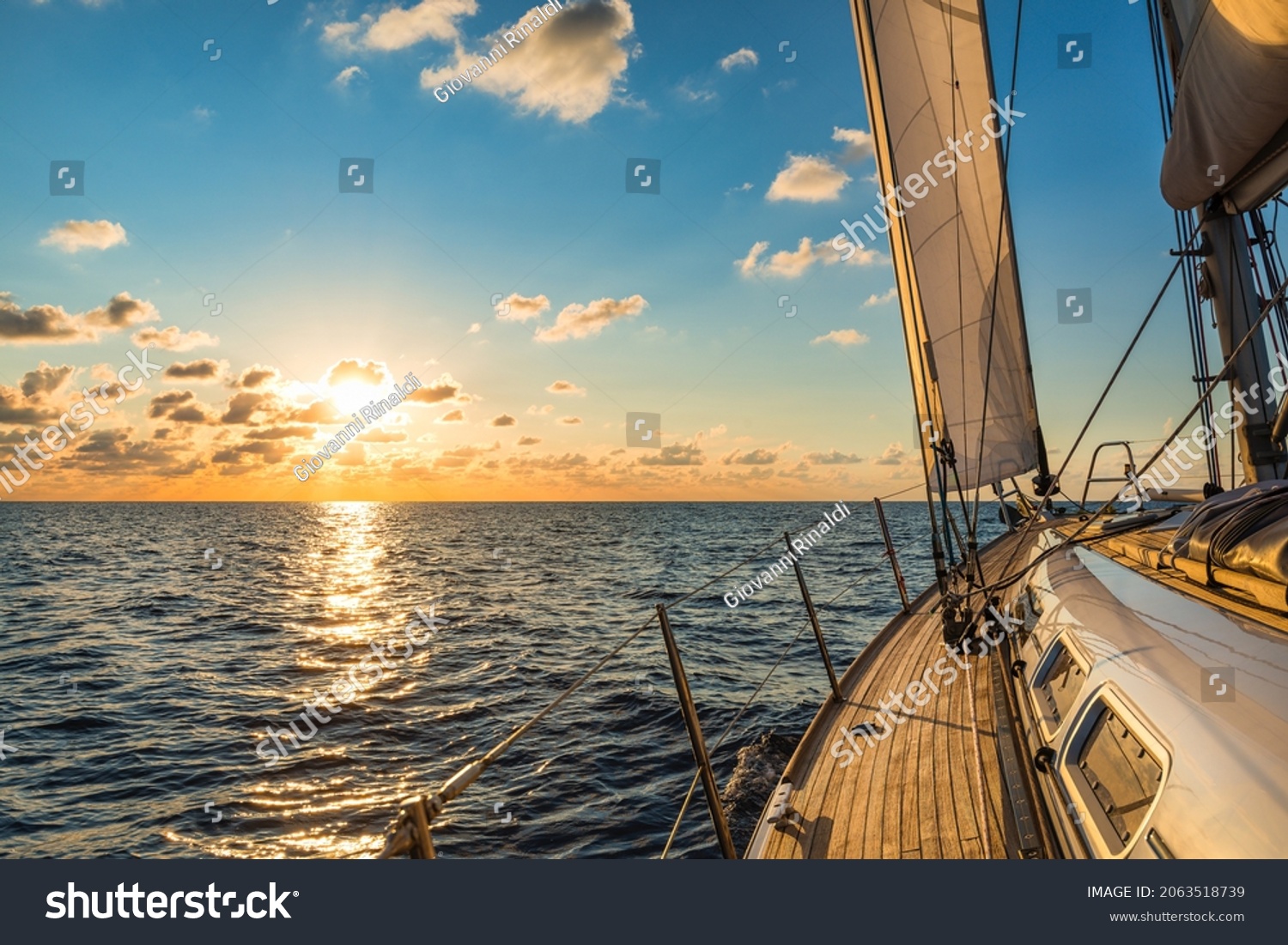 Cruising sailboat sailing in the Mediterranean Sea at sunset #2063518739