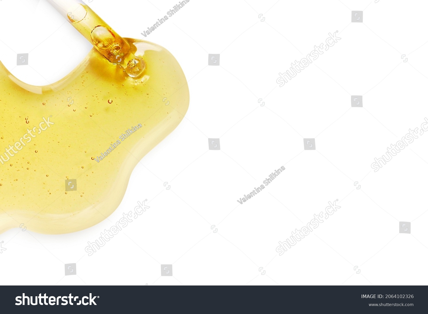 Yellow texture of a drop of whey or olive oil on a white background. Transparent sample of cosmetic gel with bubbles. Golden acid cream. Vitamin c. A drop of honey. Hyaluronic acid. #2064102326