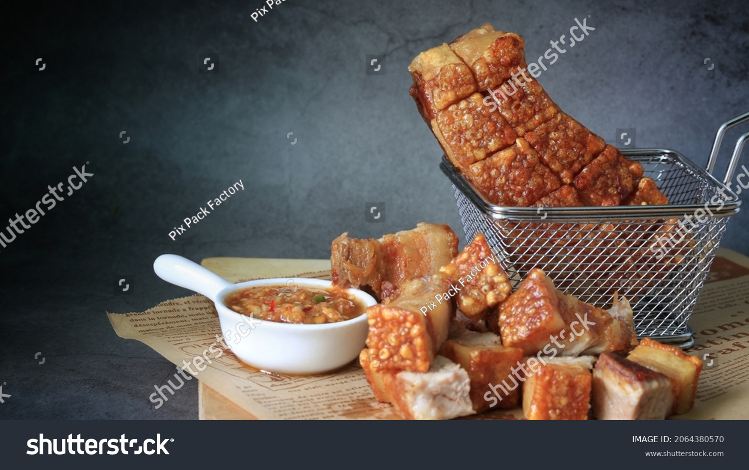 crispy pork belly in a basket with spicy sauce  #2064380570