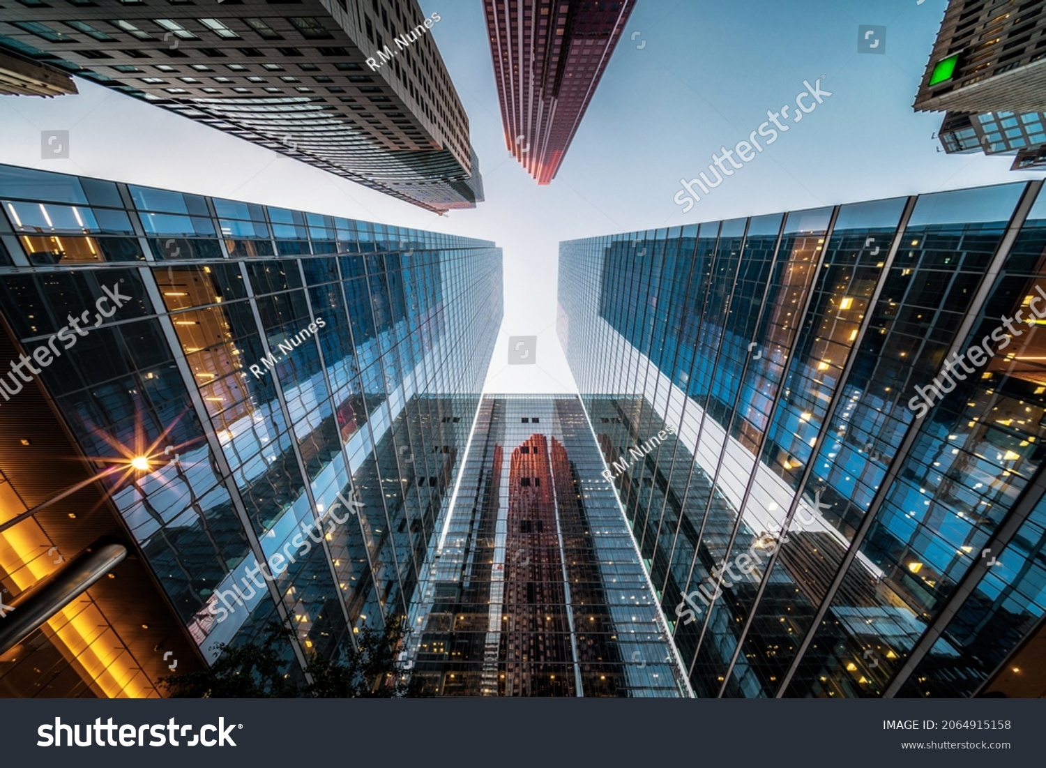 Business and finance concept, looking up at high rise office building architecture in the financial district of a modern metropolis. #2064915158