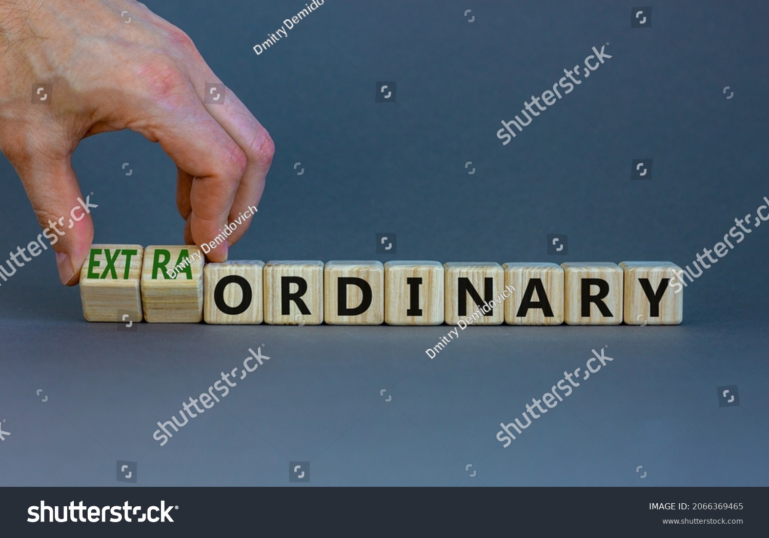 Ordinary or extraordinary symbol. Businessman turnes wooden cubes and changes words 'Ordinary extraordinary'. Beautiful grey background. Business, ordinary or extraordinary concept. Copy space. #2066369465