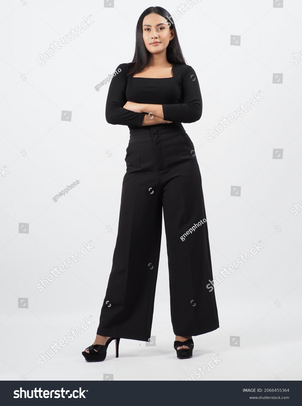 Asian woman full body. Thai woman in a modern chic style stands in white studio with elegant and confident pose. Casting model supporting actor actress. Asian woman fullbody pose in front of camera. #2066455364