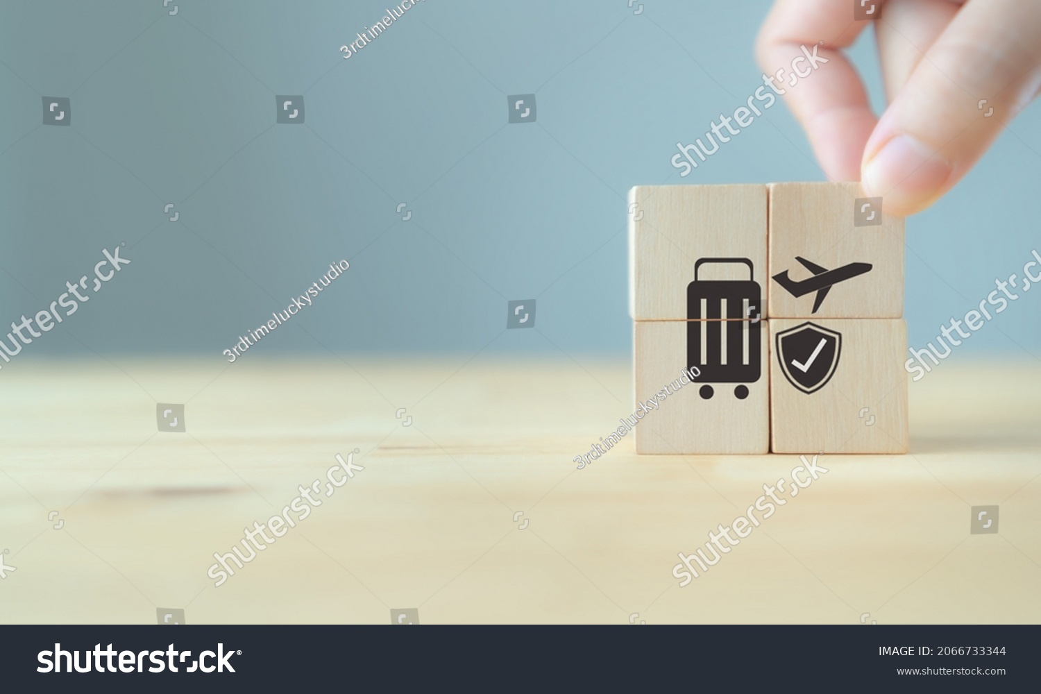 Travel safety and travel insurance concept ;wooden cube with grey background, copy space. Intended to cover medical expenses, trip cancellation, lost luggage and other losses incurred while traveling. #2066733344