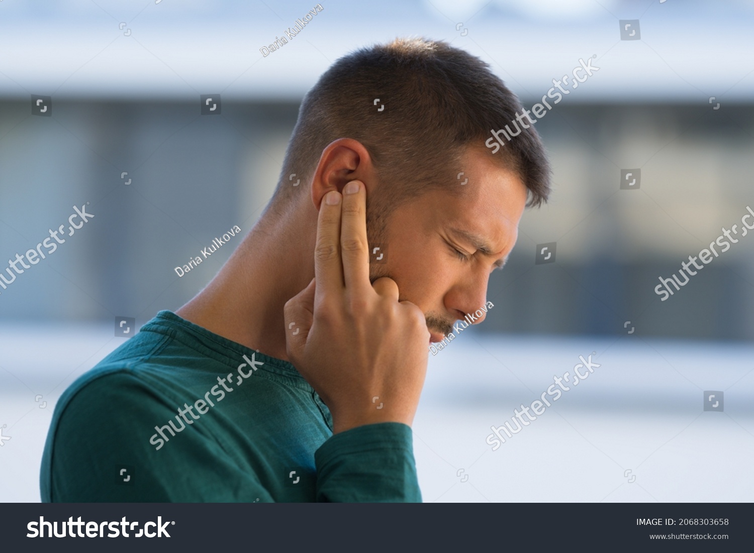 Man with tinnitus. Man touching his ear because of strong earache or ear pain. Otitis #2068303658