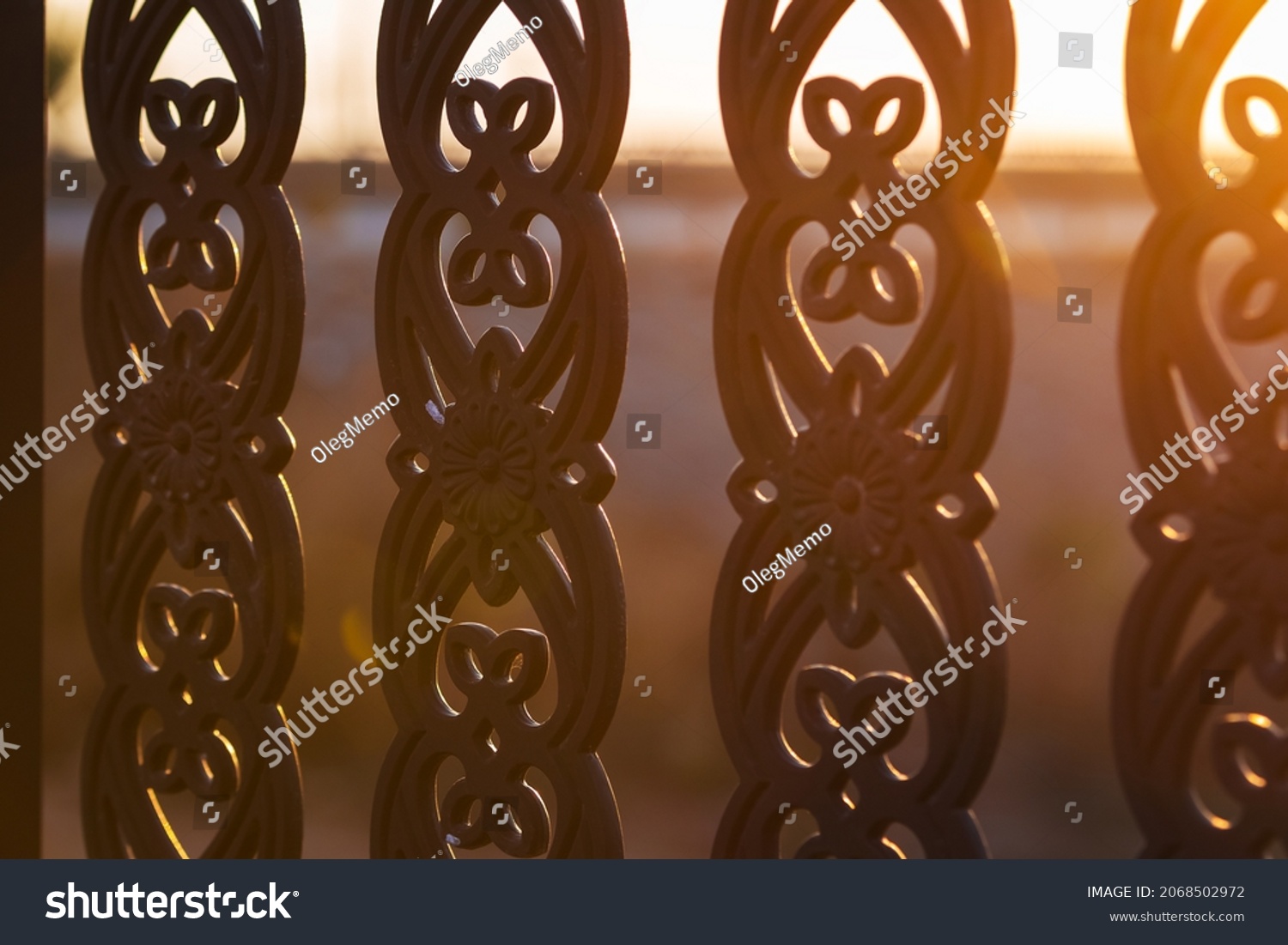 close up metal tracery fence at sunset time #2068502972