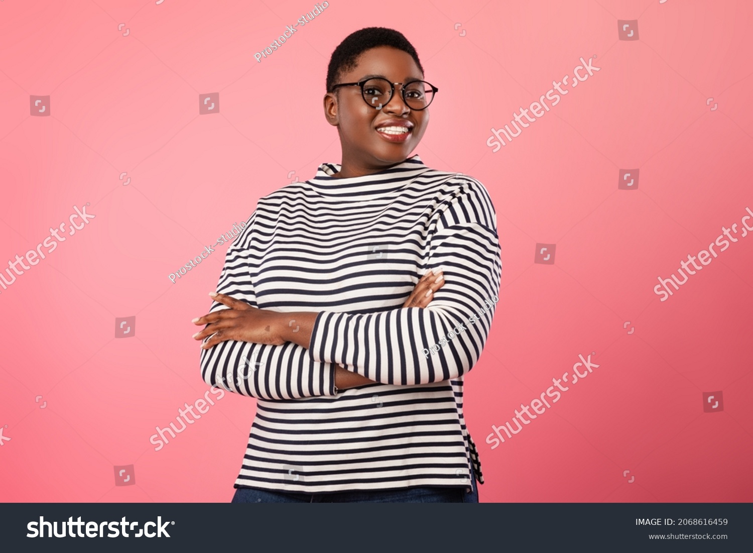 Happy Plus Size Black Woman Wearing Eyeglasses Smiling To Camera Standing Over Pink Background. Cheerful Millennial Female In Eyewear Posing In Studio #2068616459