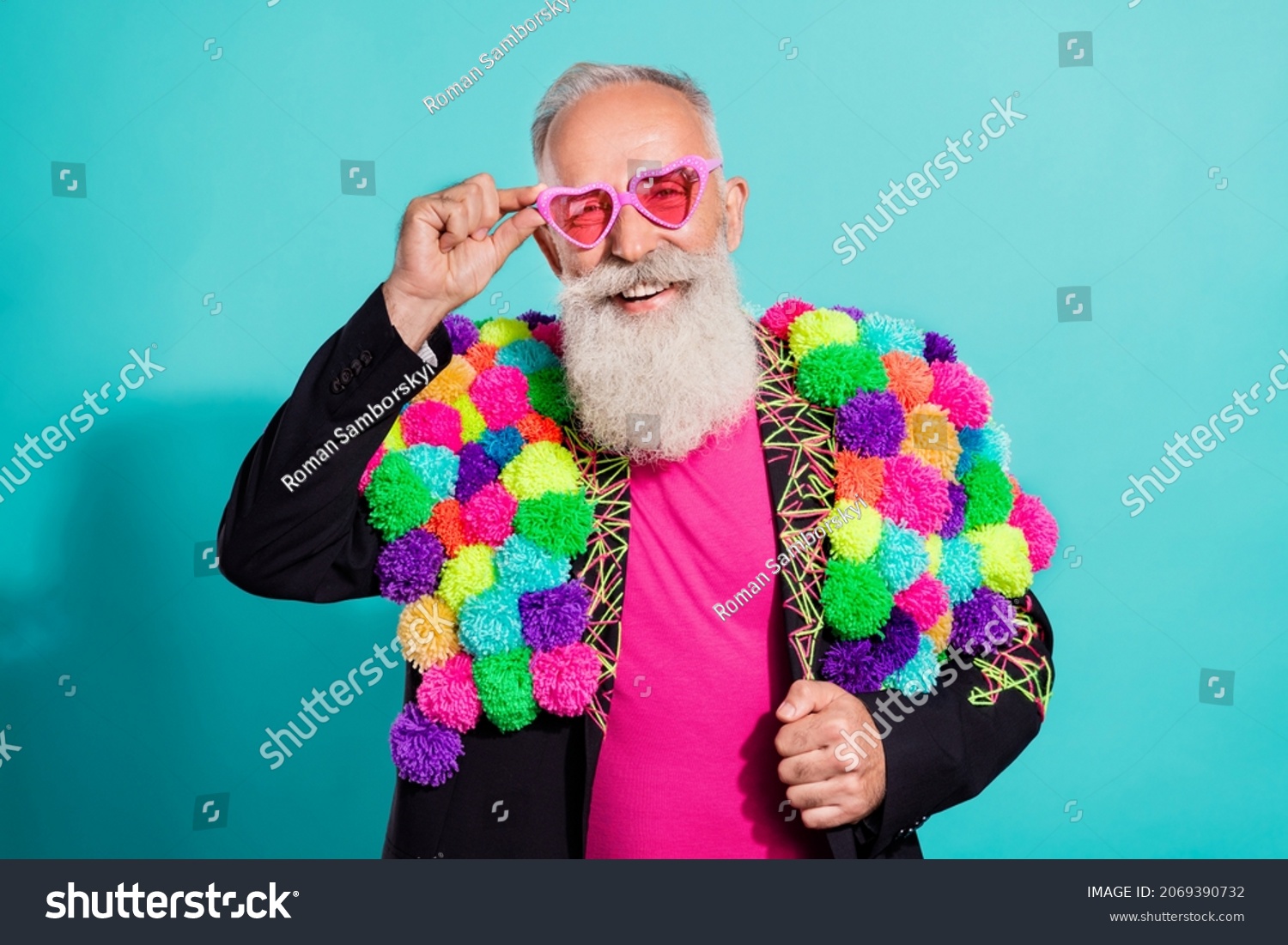 Photo of funky cool senior hipster wear handmade pop-pom blazer arm eyeglasses smiling isolated teal color background #2069390732