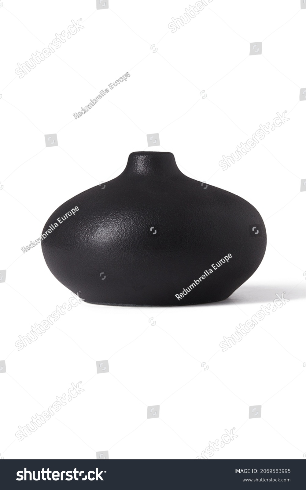 Detailed shot of a black vase. The vase is short and with a narrow neck. The surface of the vase is textured. The black decor item is isolated on the white background. #2069583995