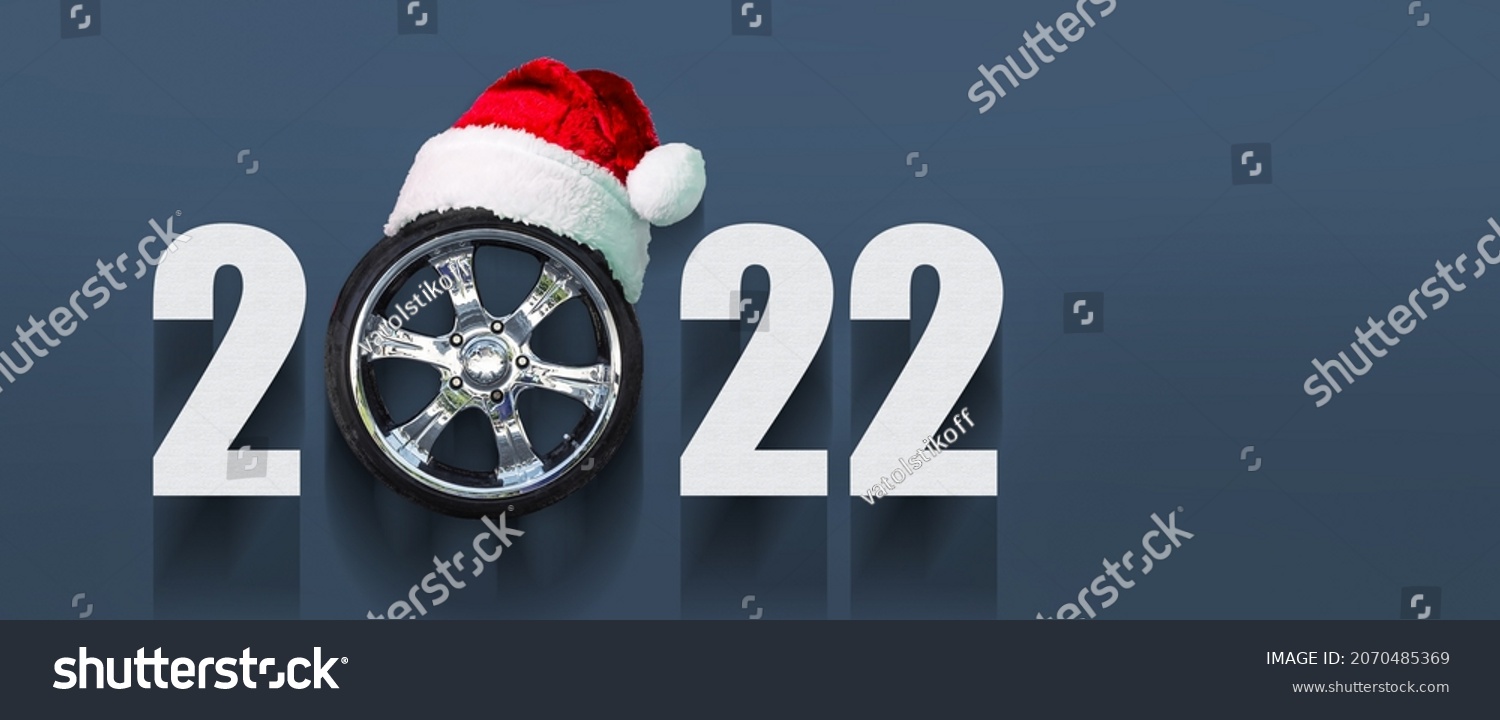 2022 Auto wheel in Santa's hat. New Year banner for auto workshop, auto shop. Copy space. Place for your text. Business. Background. #2070485369