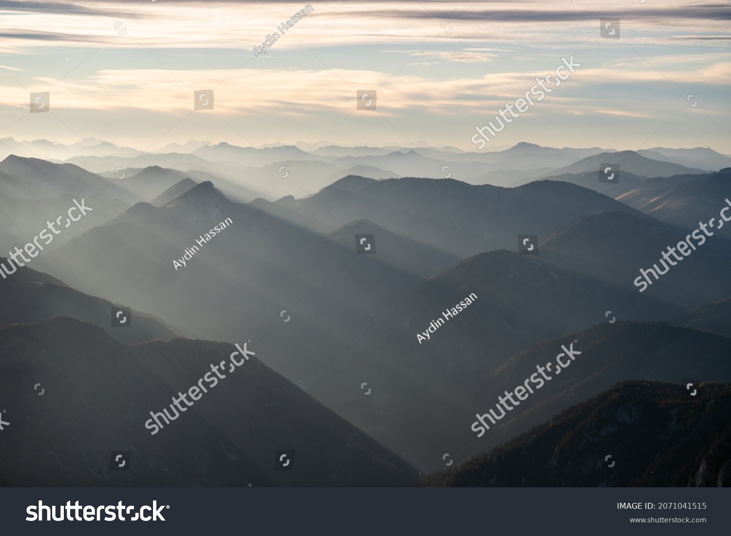 Diffused light during a sunset over the mountain peaks of Austria from Schneeberg during forest fires, Lower Austria, Austria #2071041515