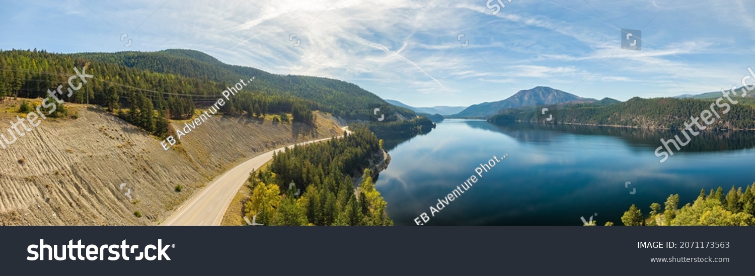 Aerial panoramic view of a scenic highway around mountains. East Kootenay, BC, Canada. #2071173563