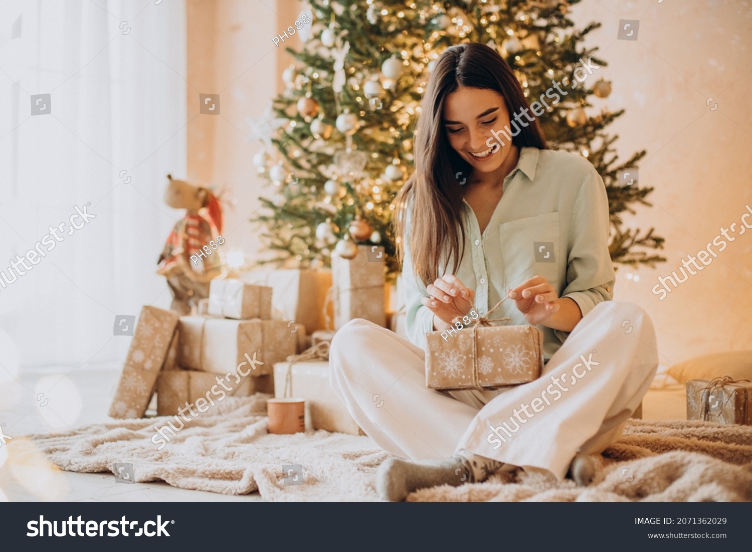 Woman opening her present on Christmas #2071362029