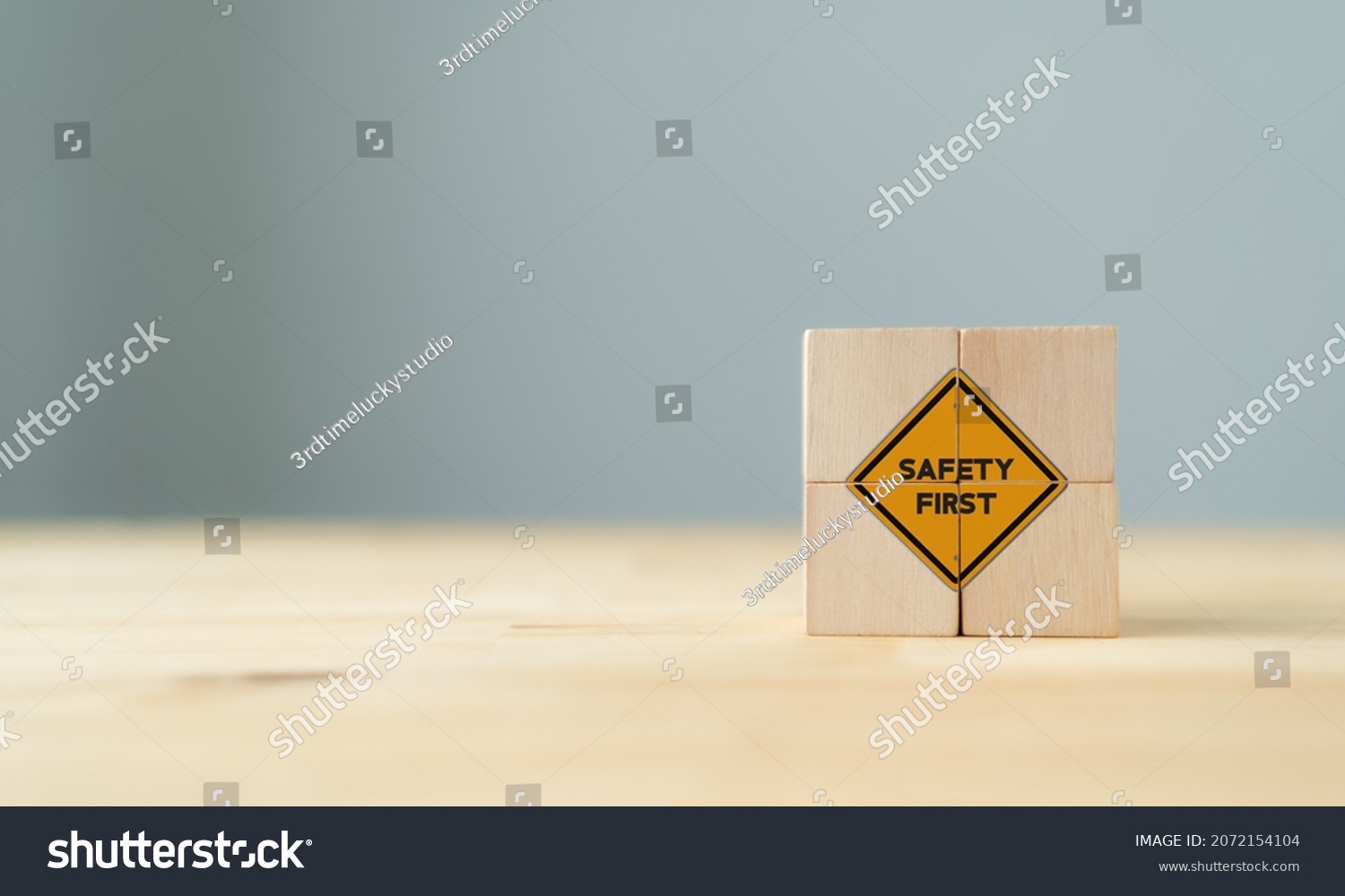Safety symbols and first signs, work safety, caution work hazards, danger surveillance, zero accident concept on wooden cubes with beautiful  grey background and copy space. Safety banner.
 #2072154104