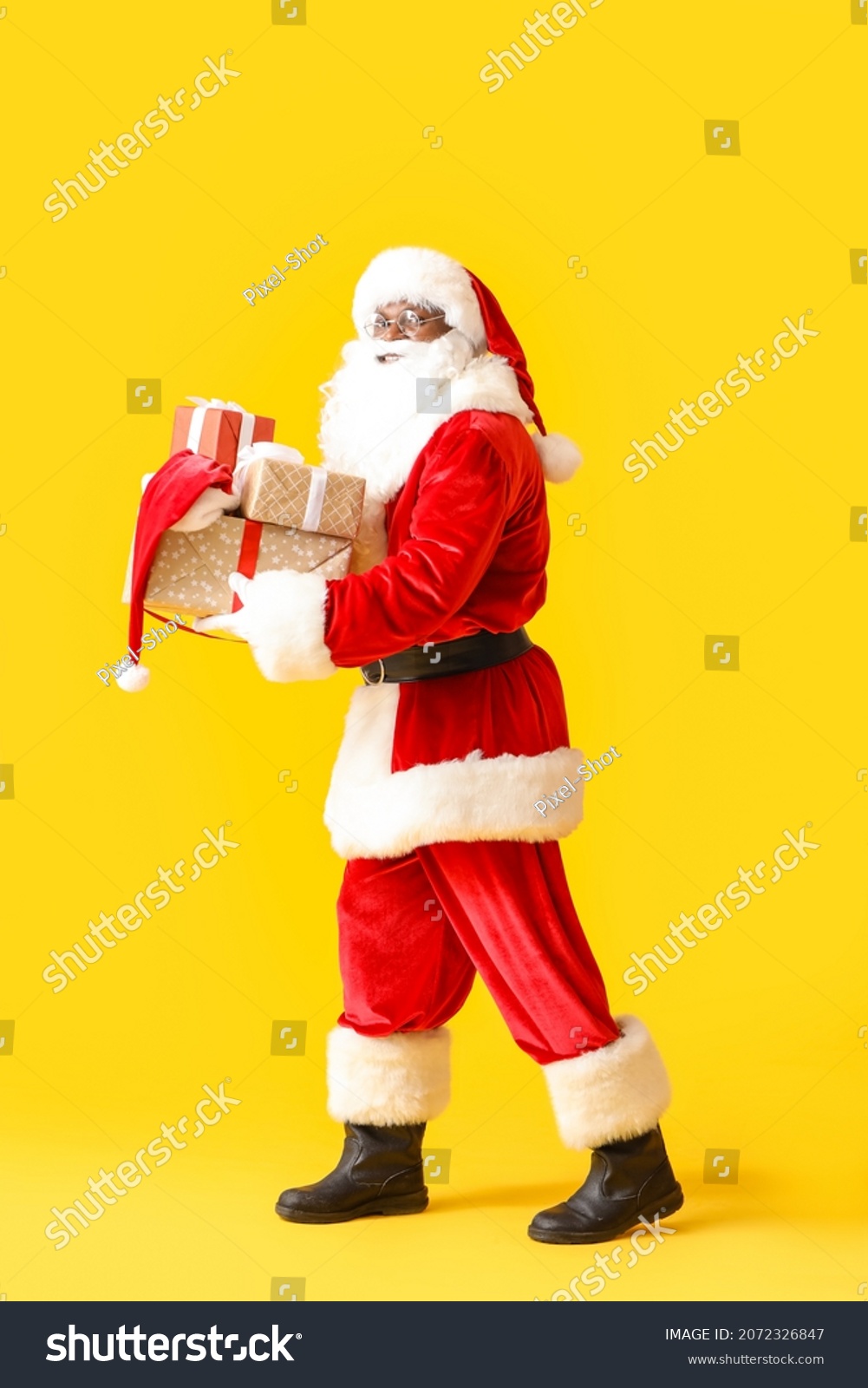African-American Santa Claus with gifts on color background #2072326847
