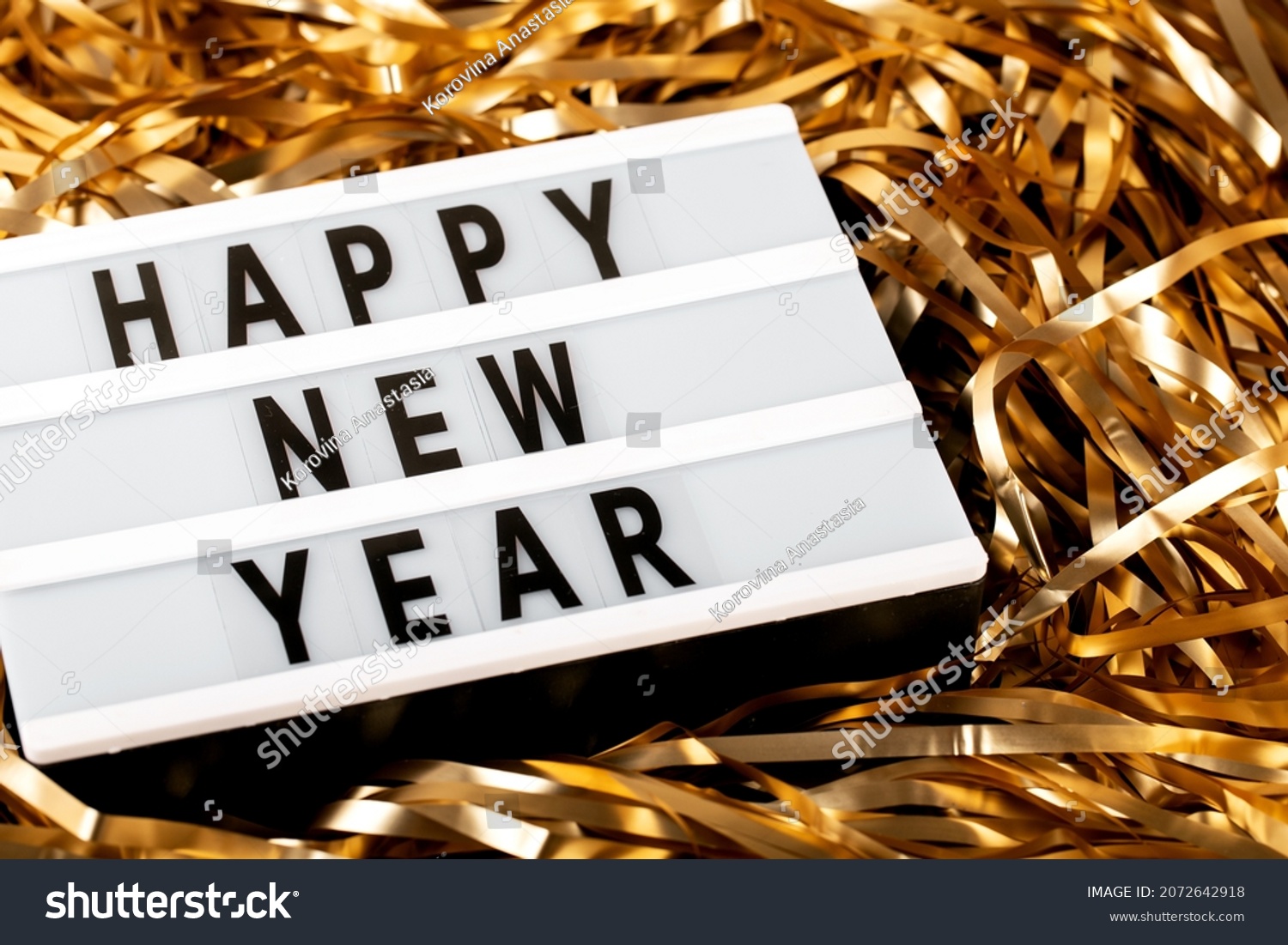 happy new year inscription in golden tinsel, side  view, holiday #2072642918