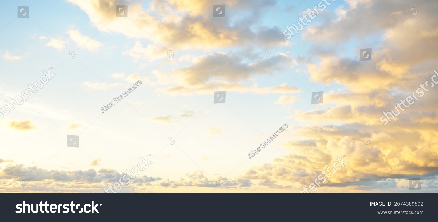 Clear blue sky, pink and golden cirrus and cumulus clouds after storm at sunset. Dramatic cloudscape. Concept art, meteorology, heaven, hope, peace, graphic resources, picturesque panoramic scenery #2074389592