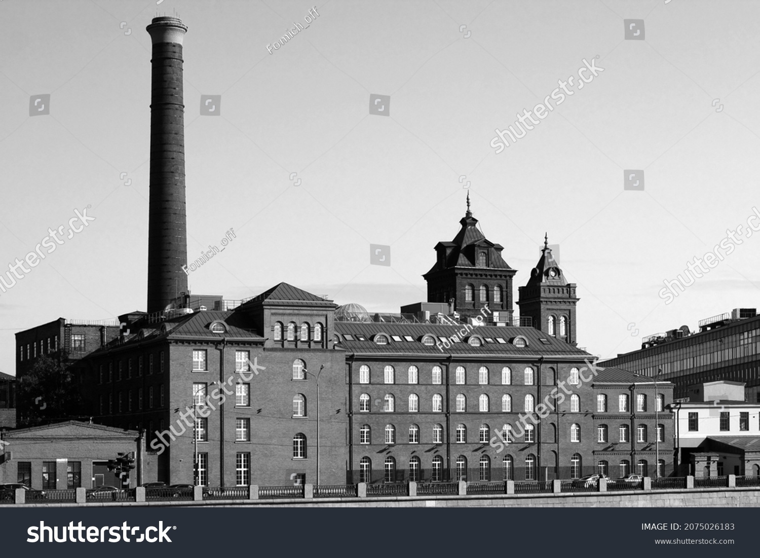 Old factory building, built in the 19th century of brick with a high chimney. Black and white photo #2075026183