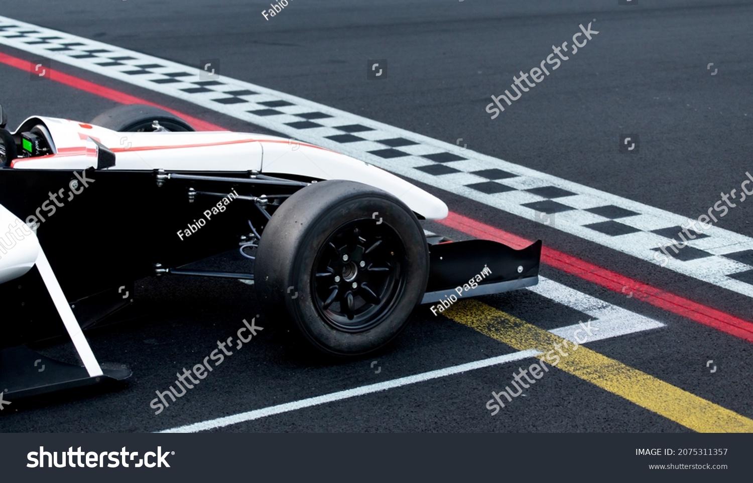 Race start first place concept, formula car nose detail on asphalt racetrack with checkered line #2075311357
