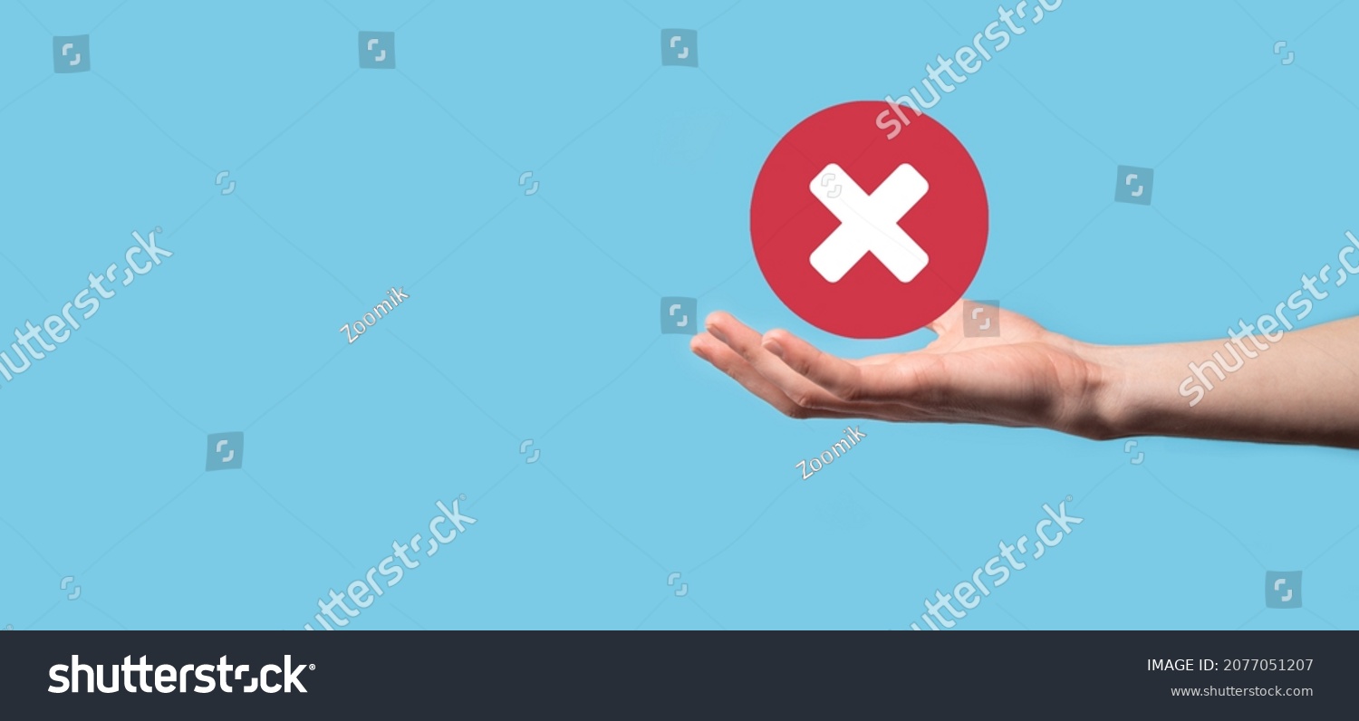 Hand holds icon,cancellation symbol,cancel icon.Cross mark flat red icon.round X mark.cancel button.Wrong.cross mark rejection.Declined.On dark background.Banner.Copy space.Place for text #2077051207