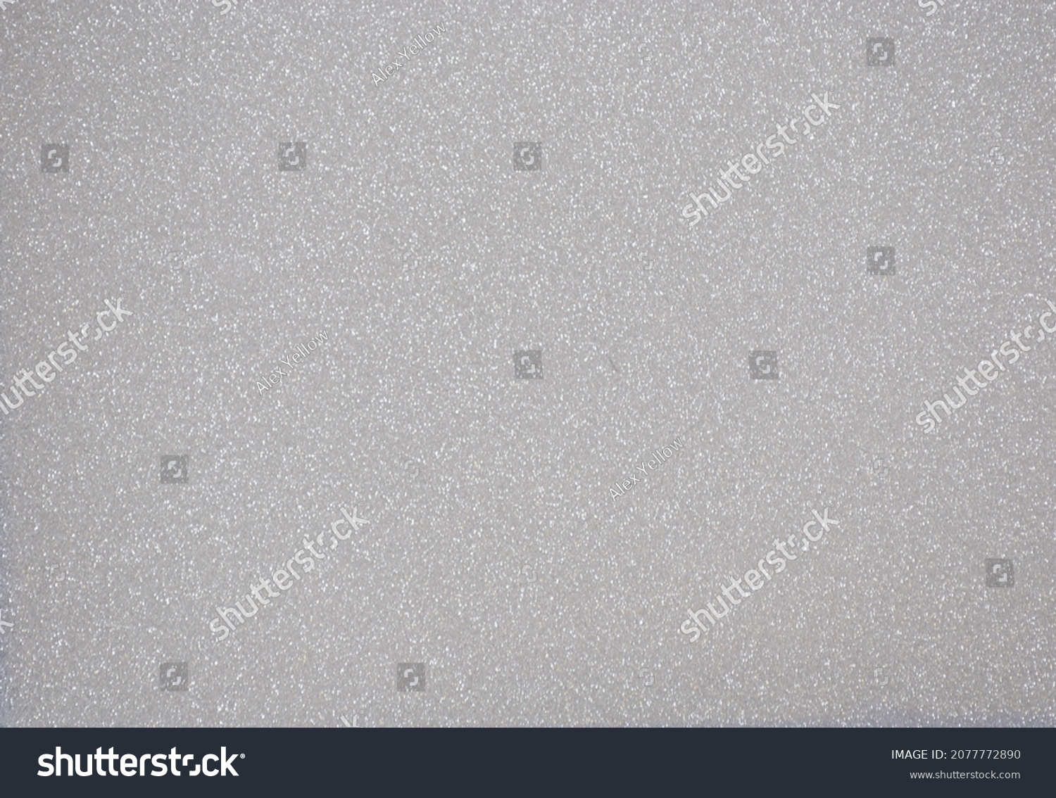 Monochrome dark gray surface with a scattering of small silvery sparkles. Background, pattern, texture. #2077772890