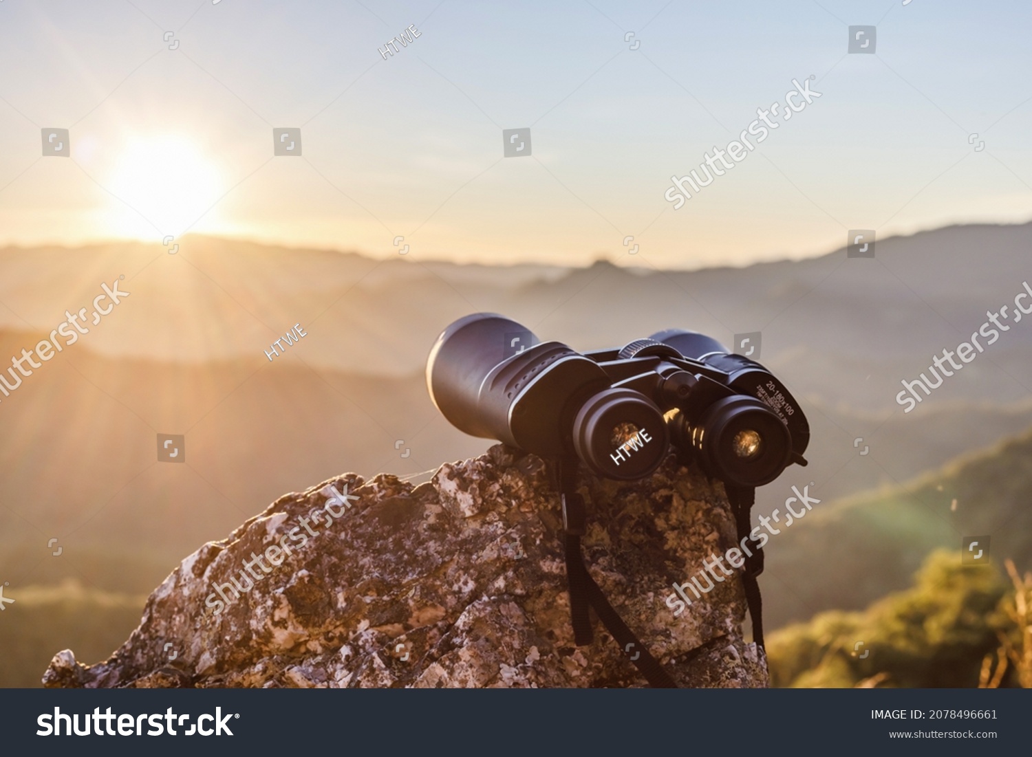binoculars on top of rock mountain at beautiful sunset background. #2078496661