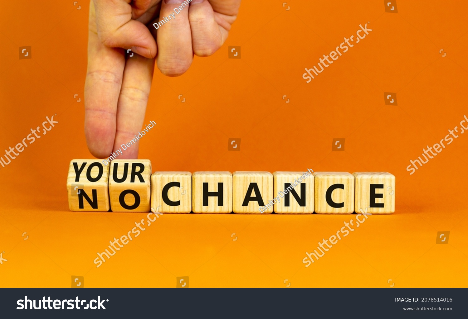 Your or my chance symbol. Businessman turns wooden cubes and changes words 'my chance' to 'your chance'. Beautiful orange background, copy space. Business and your or my chance concept. #2078514016