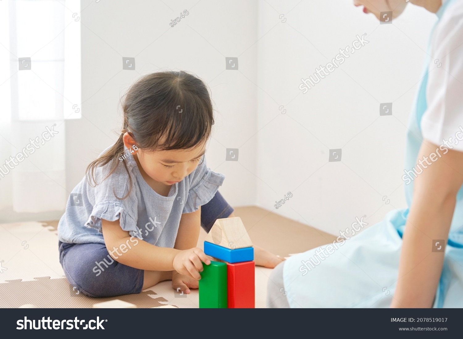Asian girl playing with the block #2078519017