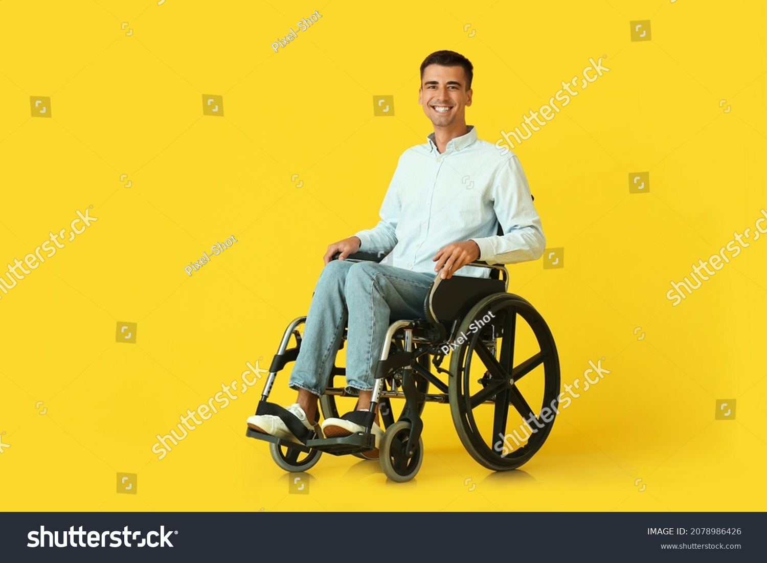 Young man in wheelchair on color background #2078986426