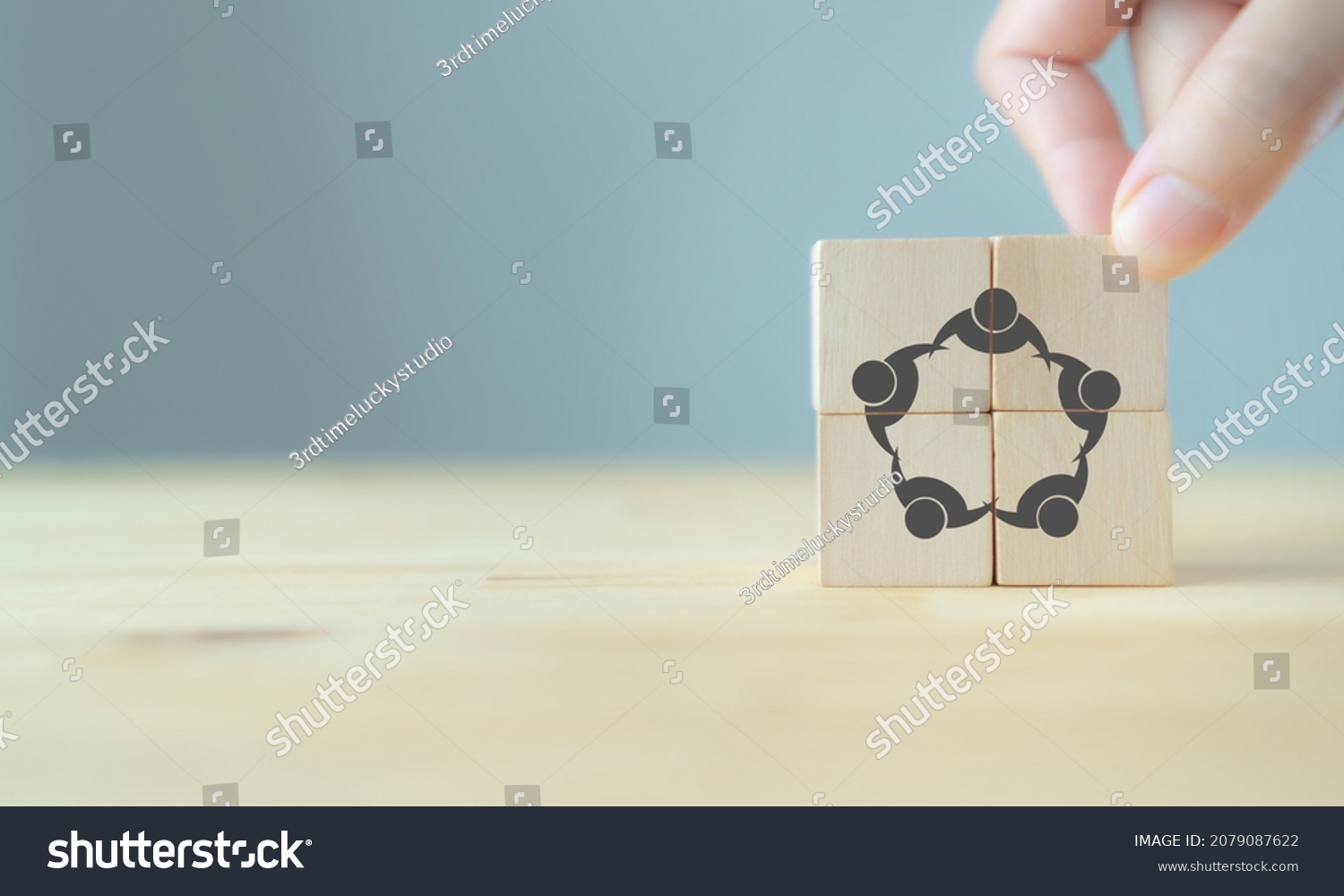 Business management concept; teamwork, collaboration, achieve a common goal. Wooden cube screening teamwork vector icon  standing on the wood table with grey background, copy space.  #2079087622