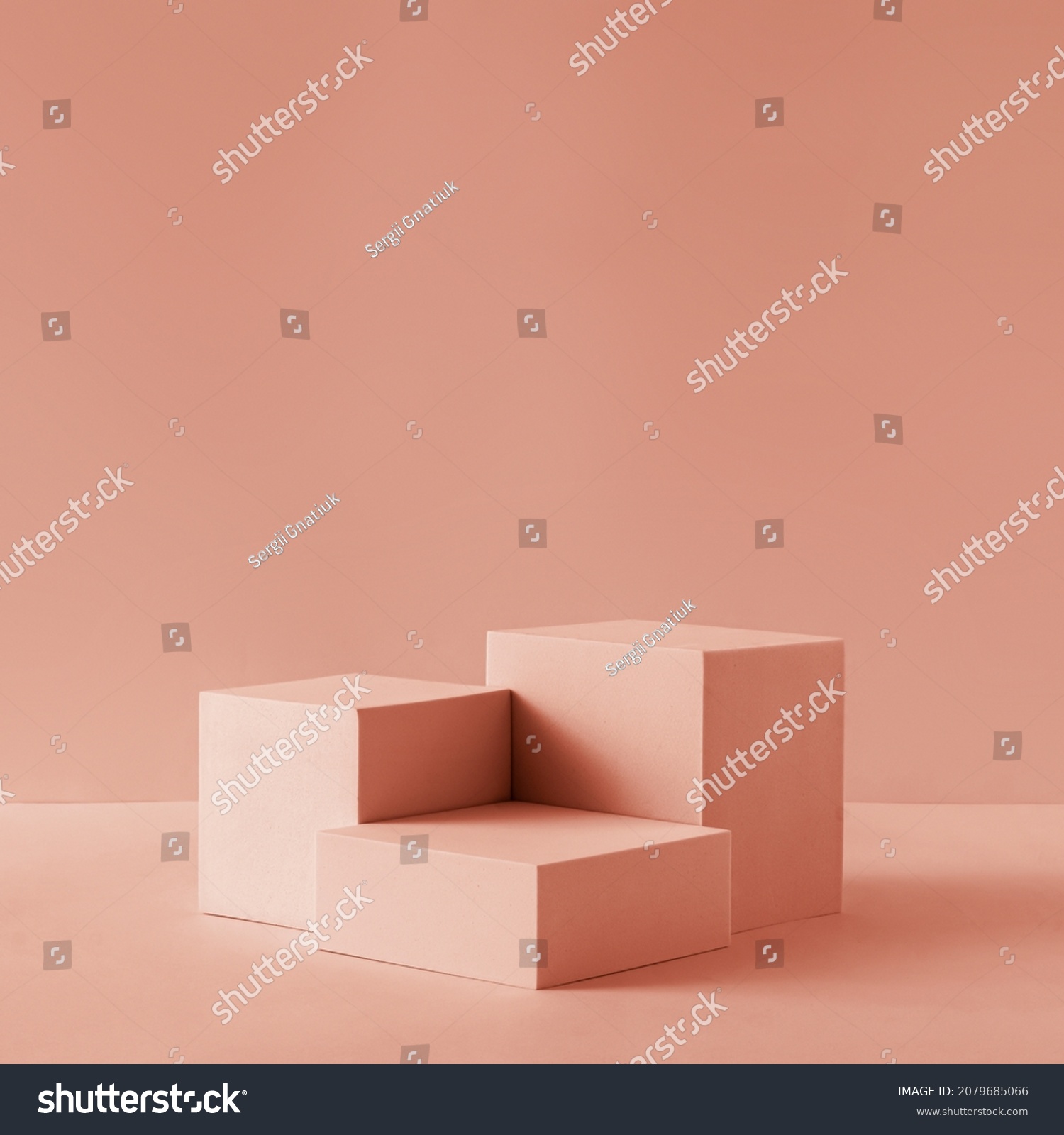 Awarding podium made of three 3d pastel square shapes of different sized against blank pink background for copy space #2079685066