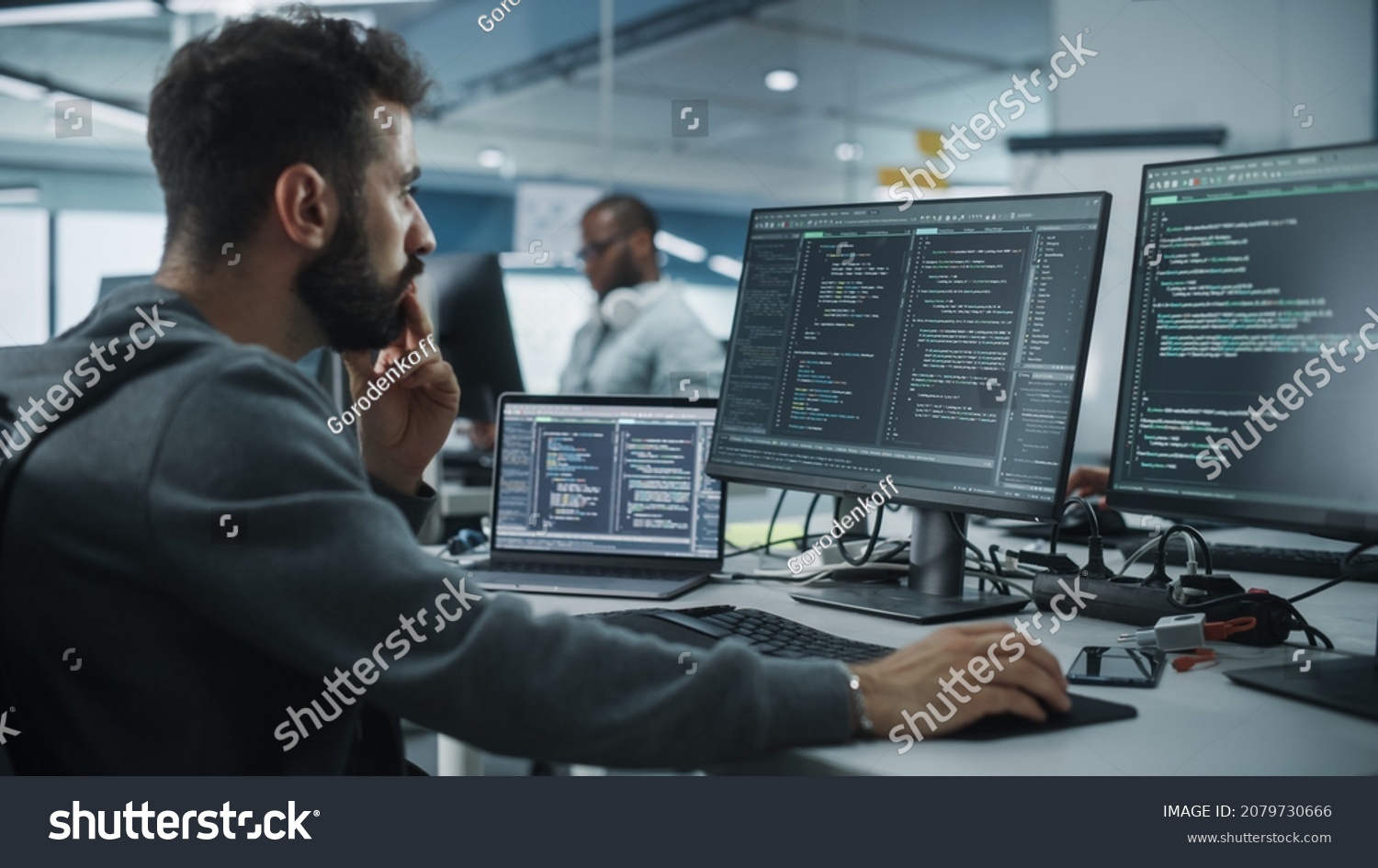 Diverse Office: Enthusiastic White IT Programmer Working on Desktop Computer. Male Specialist Creating Innovative Software. Engineer Developing App, Program, Video Game. Writing Code in Terminal #2079730666