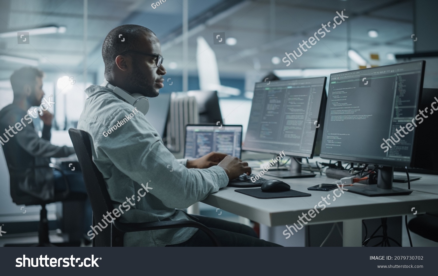 Authentic Office: Enthusiastic Black IT Programmer Starts Working on Desktop Computer. Male Website Developer, Software Engineer Developing App, Video Game. Terminal with Coding Programming Language #2079730702