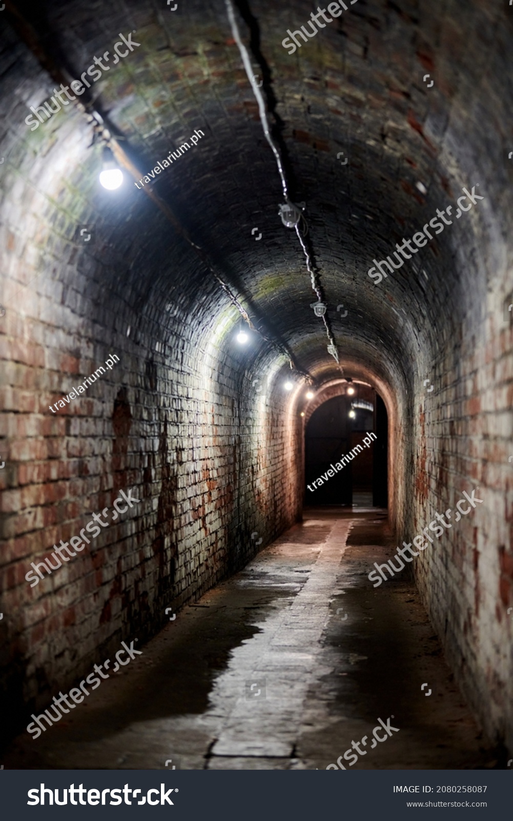 Brick tunnel in old German fort, red brick loft corridor with old wiring, industrial basement of secret military base. Secret passageway of old mansion. Fort No. 5 King Frederick William III #2080258087