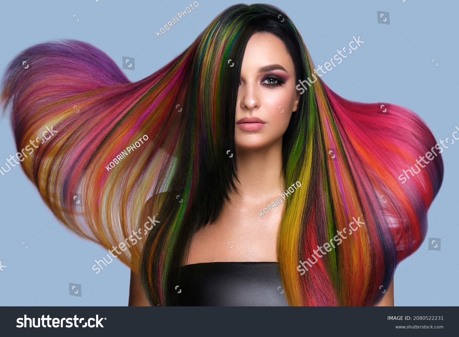 Beautiful woman with multi-colored hair and creative make up and hairstyle. Beauty face. #2080522231