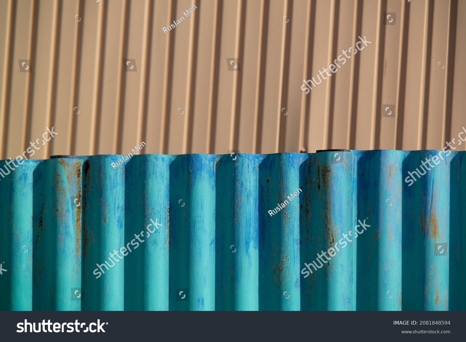 Corrugated waved cyan color fence under sunlight. #2081848594
