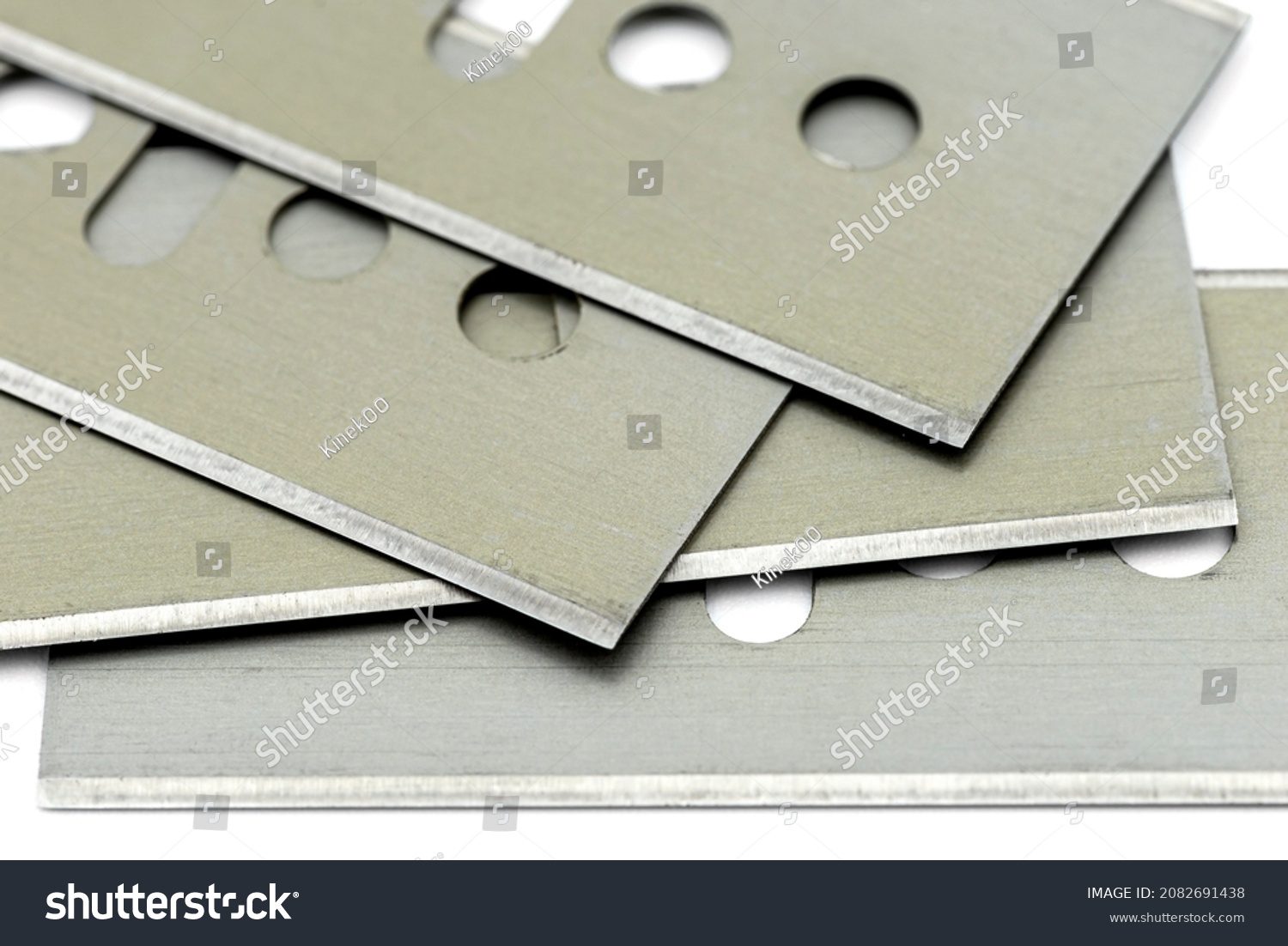 A background made from a macro photo of a pile of razor blades, isolated on a white background. #2082691438