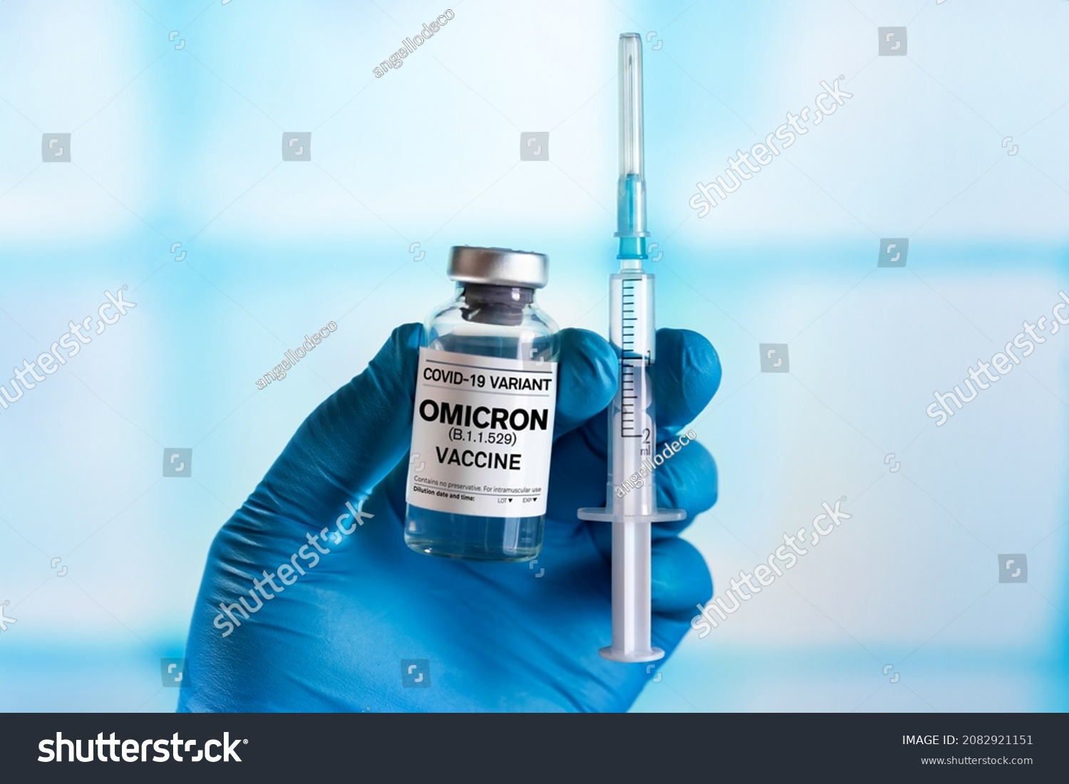 Injectable vaccine for the vaccination program of coronavirus Omicron. Doctor holds the hand Vaccine vial and syringe to administer vaccination doses for New Variant of the Covid-19 Omicron B.1.1.529 #2082921151