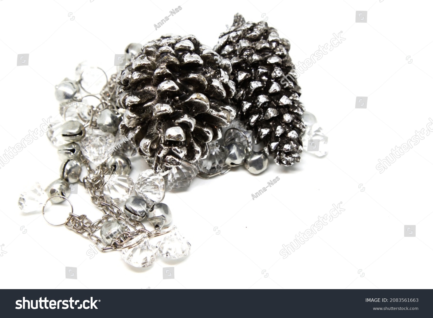 Christmas decoration silver pine and garland with small silver bell. Selective focus. High quality photo #2083561663
