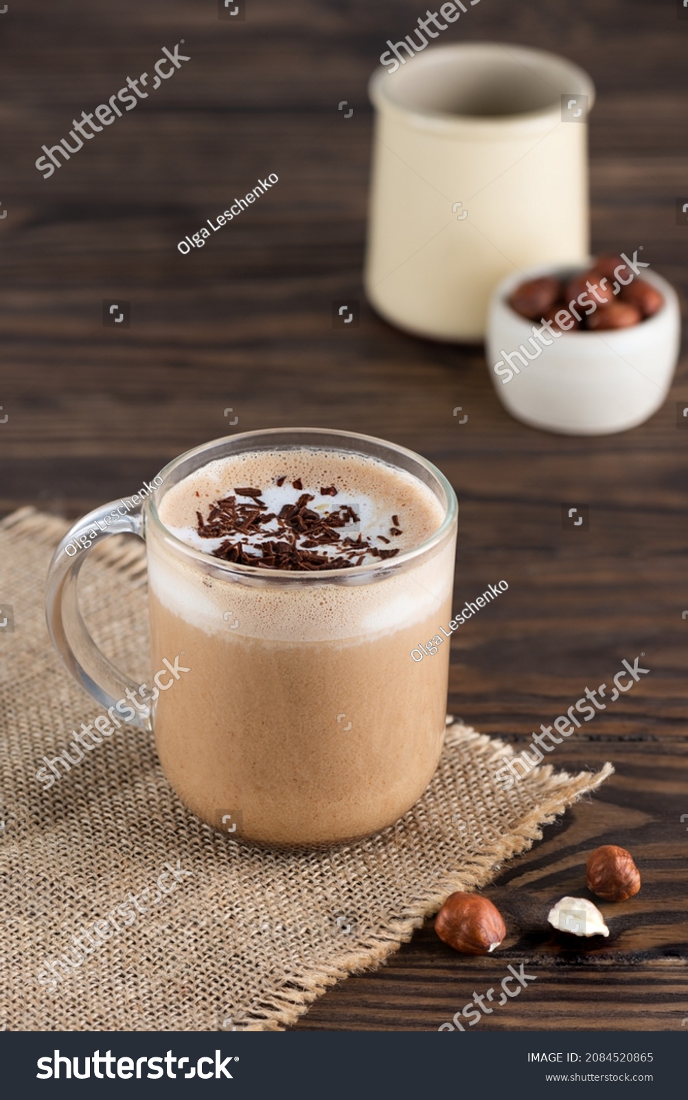 Hazelnut moсacсino coffee in a glass mug on a wooden table. #2084520865